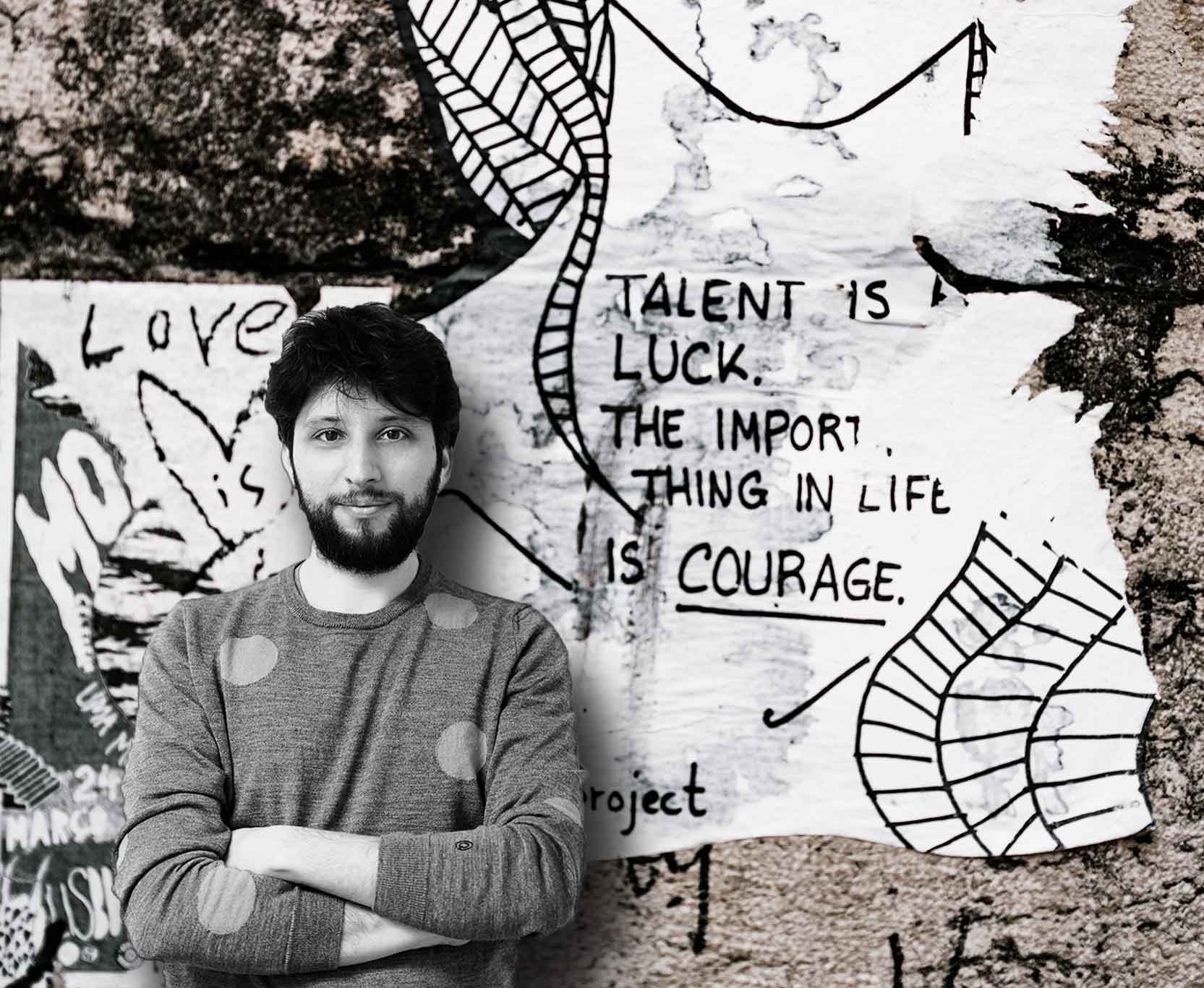 Alberto G. Valerio freelance Web Developer in front of a wall with a quote